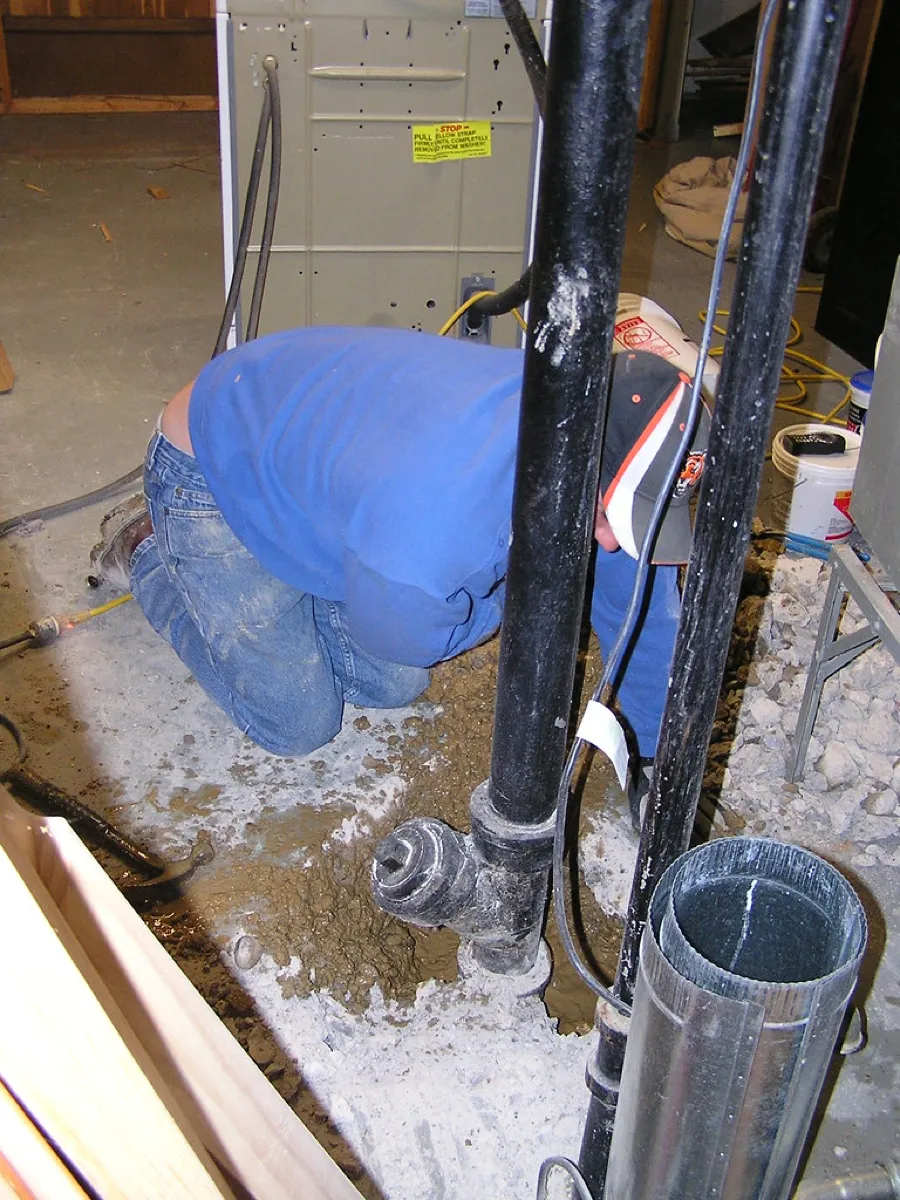 Technician servicing a residential well and pump system in Central Maine